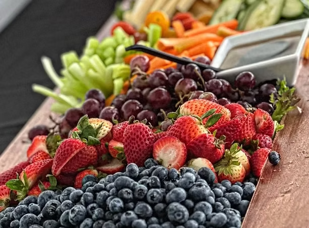 Fresh fruit and vegetable tray with strawberries, blueberries, grapes and carrots