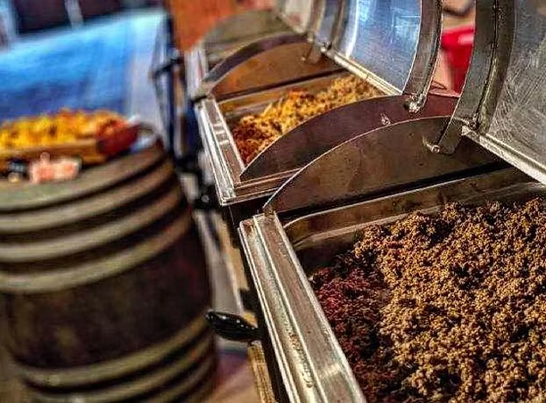 Buffet of chafing dishes with meats and sides for a wedding reception